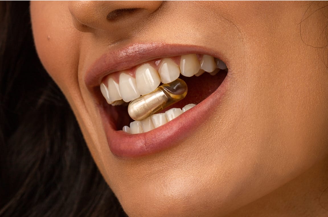 studio nunc capsify case photo campaign for website woman with vitamin pill between her teeth